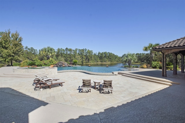 view of pool with a water view, a patio area, a gazebo, and an in ground hot tub