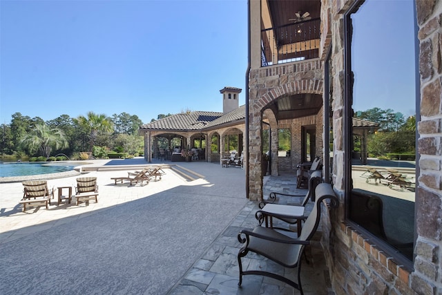 surrounding community featuring a gazebo, a patio area, and a swimming pool