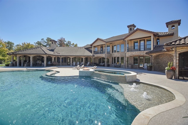 view of swimming pool featuring an in ground hot tub, a patio, and pool water feature