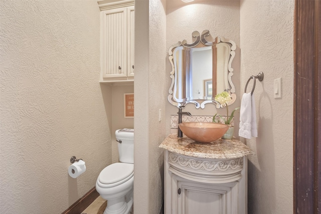 27918 Hansons Ct, Spring, TX 77386 - bathroom with a textured wall, toilet, and vanity