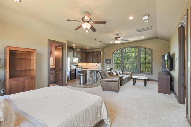 bedroom with light carpet, ceiling fan, stainless steel refrigerator, vaulted ceiling, and sink