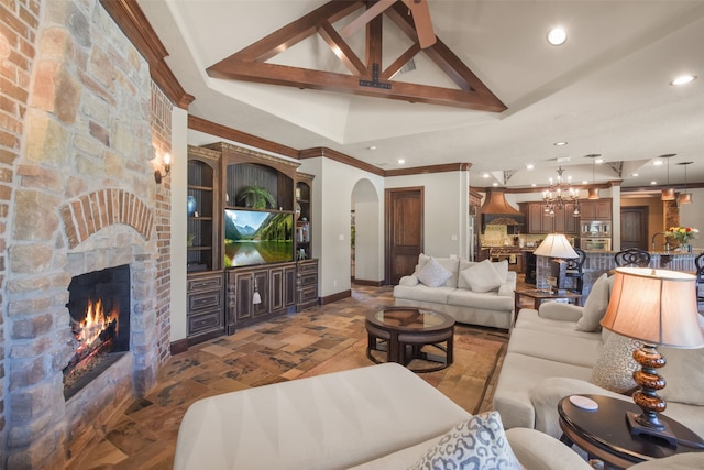 living room with ornamental molding, beamed ceiling, dark wood-type flooring, a fireplace, and a notable chandelier