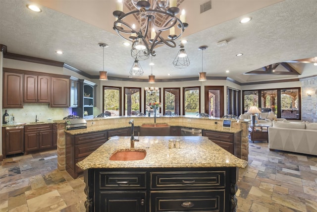 27918 Hansons Ct, Spring, TX 77386 - kitchen featuring a spacious island, stone tile flooring, a textured ceiling, a chandelier, and open floor plan