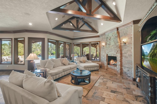 27918 Hansons Ct, Spring, TX 77386 - living area with a textured ceiling, stone tile floors, a fireplace, crown molding, and recessed lighting