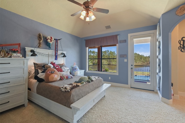 bedroom featuring ceiling fan, vaulted ceiling, light colored carpet, and access to exterior