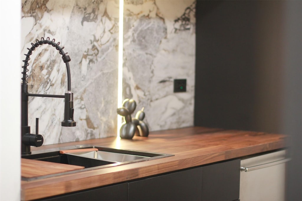 3525 Sage Rd Unit 1213, Houston, TX 77056 - interior details featuring a sink and wooden counters