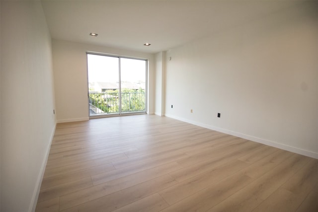 unfurnished room with light hardwood / wood-style flooring