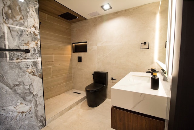 bathroom featuring tile walls, vanity, a shower, and toilet