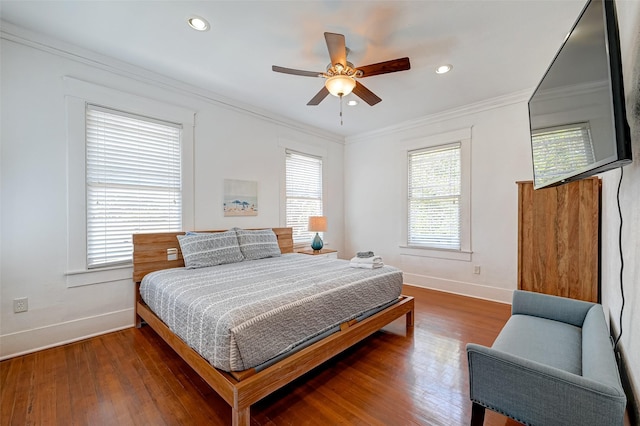 bedroom with dark wood-type flooring, ceiling fan, and ornamental molding