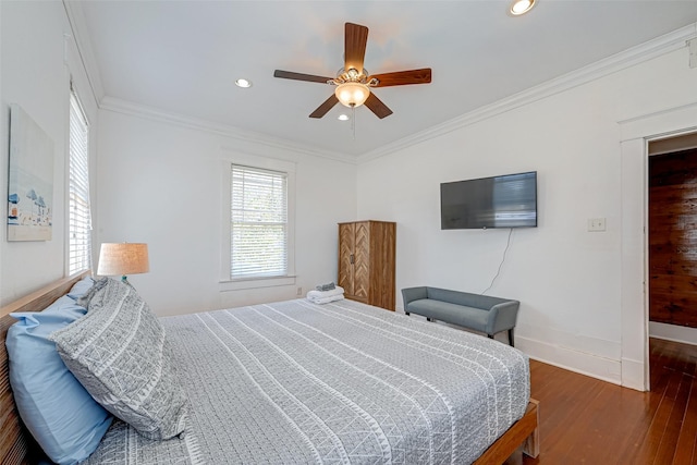 bedroom with crown molding, ceiling fan, and dark hardwood / wood-style flooring