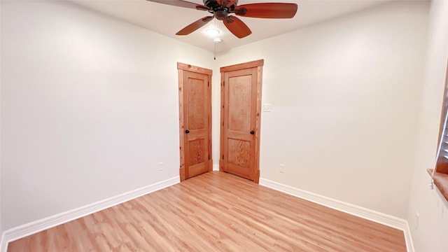 unfurnished room featuring light hardwood / wood-style flooring and ceiling fan