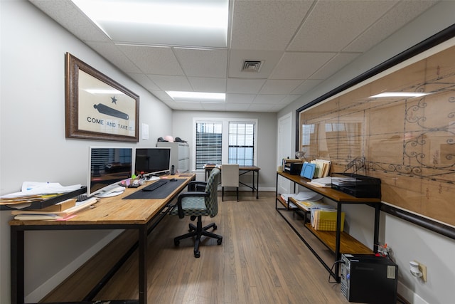 home office featuring a paneled ceiling and hardwood / wood-style floors