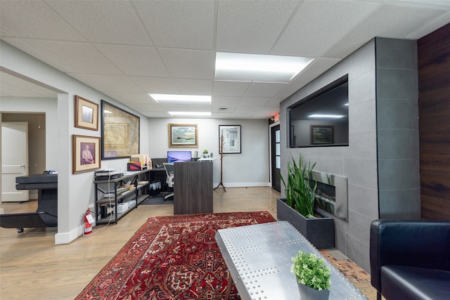 office featuring light hardwood / wood-style floors and a paneled ceiling