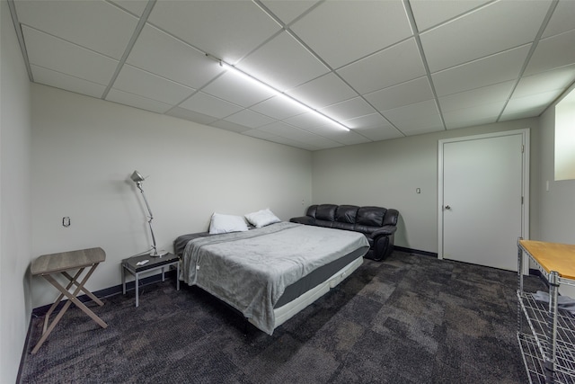 carpeted bedroom featuring a paneled ceiling