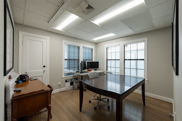 home office featuring wood-type flooring and a paneled ceiling