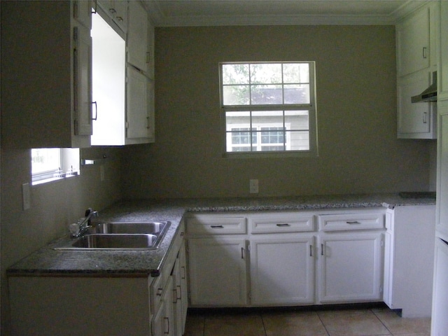 kitchen featuring white cabinetry, crown molding, sink, and light tile patterned floors