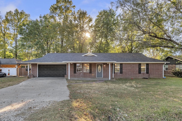 ranch-style house with a garage and a front lawn