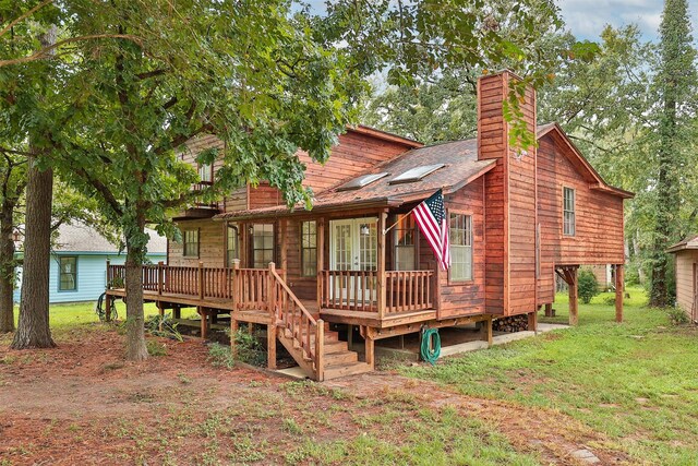 rear view of property with a yard