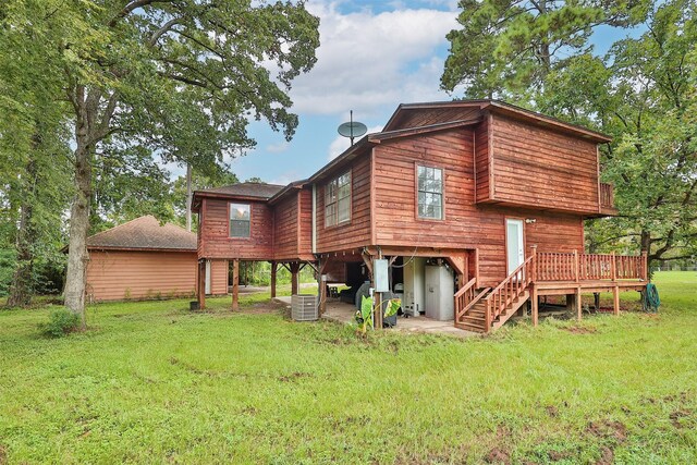 back of property with a patio area, a deck, and a lawn