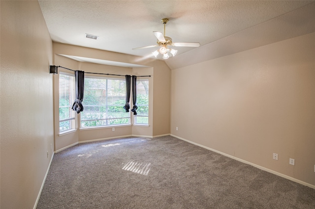 carpeted spare room featuring a textured ceiling and ceiling fan