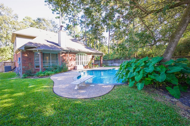 view of pool featuring a yard and a patio