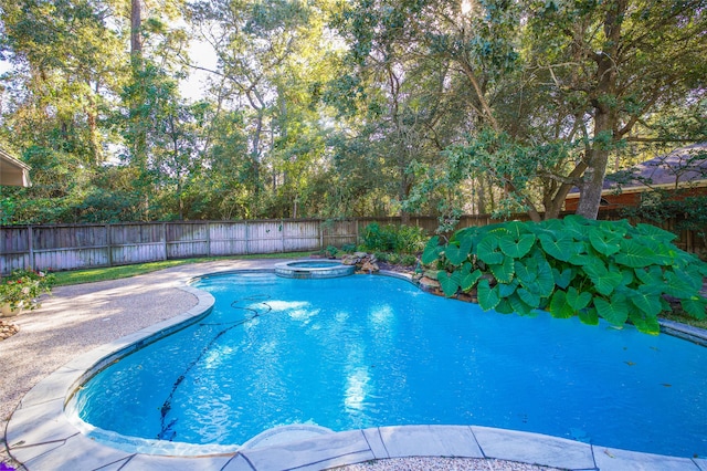 view of pool with an in ground hot tub