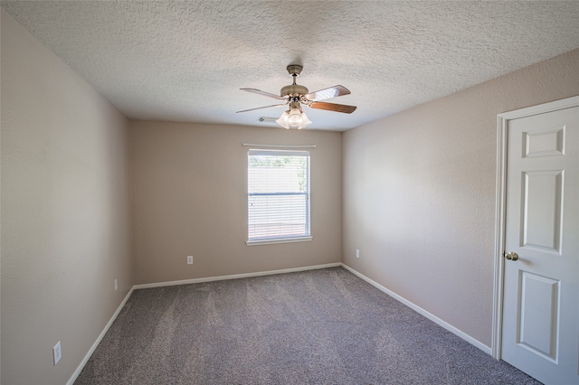 carpeted spare room featuring a textured ceiling and ceiling fan