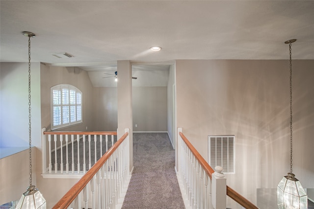 hall featuring carpet and vaulted ceiling