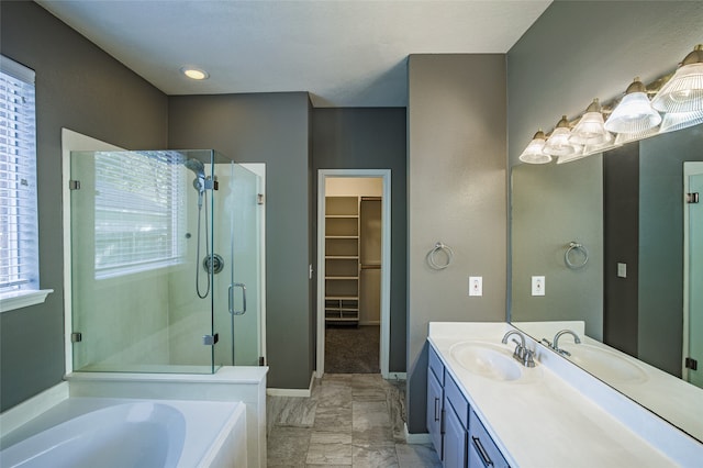 bathroom with vanity, independent shower and bath, and plenty of natural light