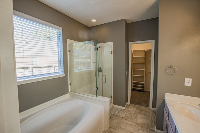 bathroom featuring vanity and separate shower and tub