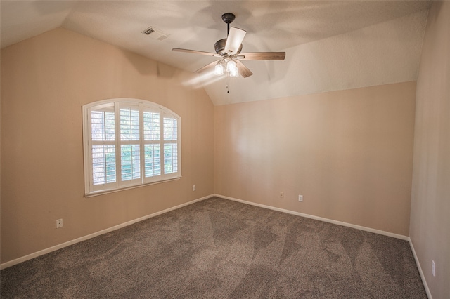 spare room featuring vaulted ceiling, carpet flooring, and ceiling fan