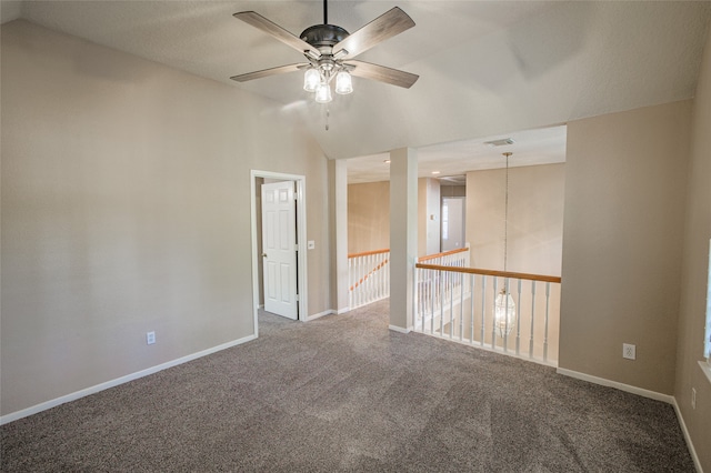 carpeted empty room with vaulted ceiling and ceiling fan