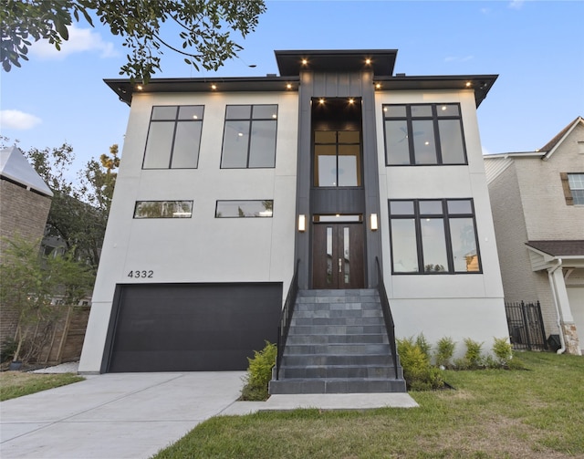 modern home featuring a front yard and a garage