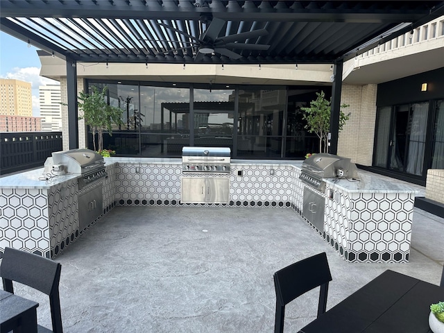 view of patio / terrace with an outdoor kitchen, a grill, and ceiling fan