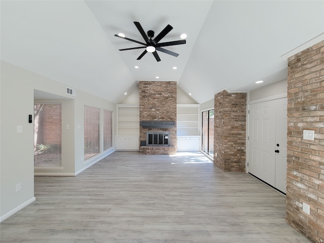 unfurnished living room featuring high vaulted ceiling, a fireplace, light hardwood / wood-style floors, and ceiling fan