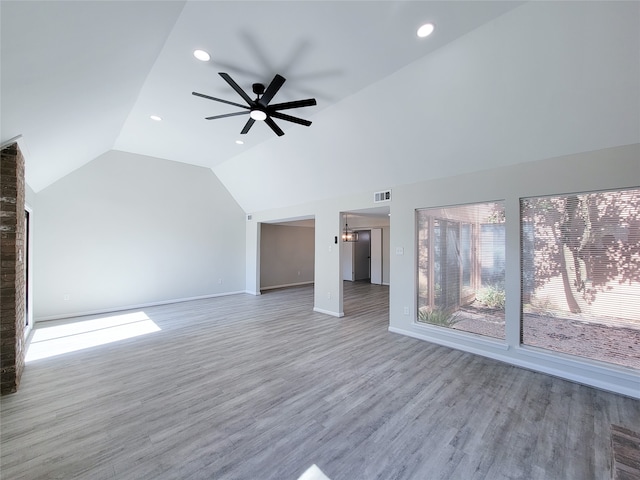 unfurnished living room featuring vaulted ceiling, wood-type flooring, and ceiling fan