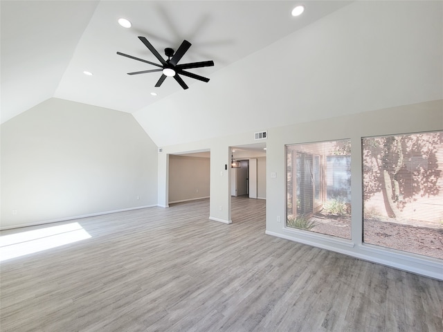 unfurnished living room featuring ceiling fan, light wood-type flooring, and vaulted ceiling