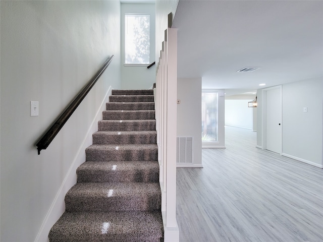 stairs with wood-type flooring