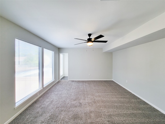 carpeted empty room featuring ceiling fan