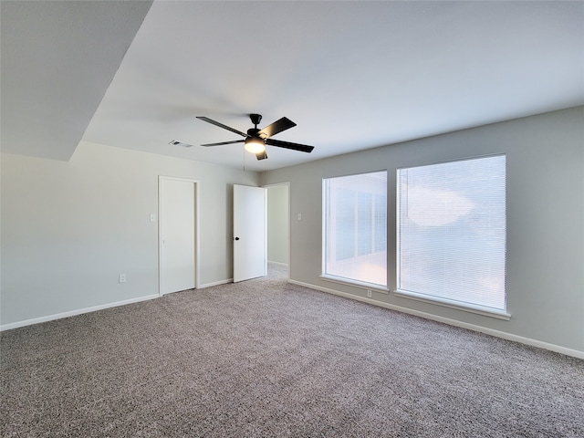 unfurnished room with carpet floors and ceiling fan