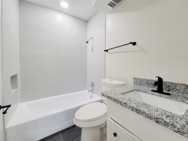 full bathroom with toilet, tiled shower / bath, vanity, and tile patterned floors