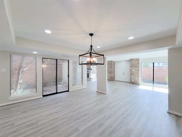 interior space featuring a chandelier and light wood-type flooring