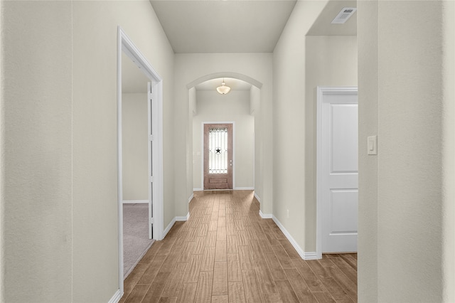 corridor with light hardwood / wood-style floors