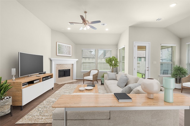 living room featuring ceiling fan, dark wood-type flooring, and vaulted ceiling