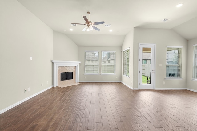 unfurnished living room featuring a healthy amount of sunlight, wood-type flooring, and ceiling fan