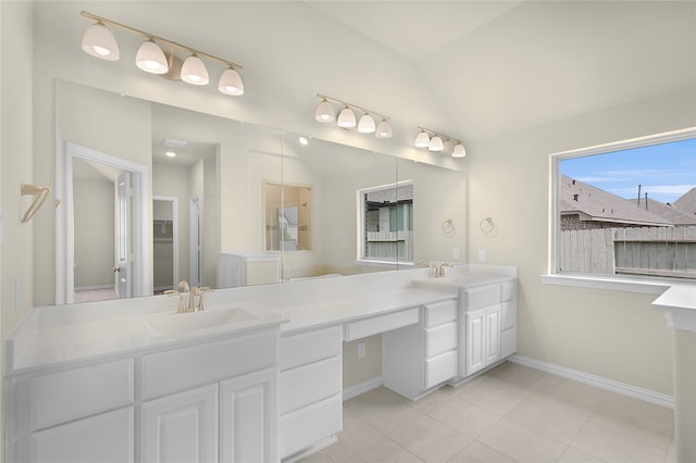 bathroom with vanity, tile patterned floors, and vaulted ceiling