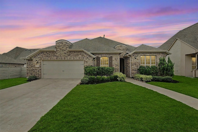 view of front of property with a yard and a garage