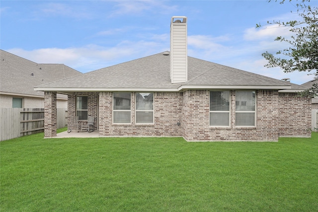 back of house featuring a yard and a patio area