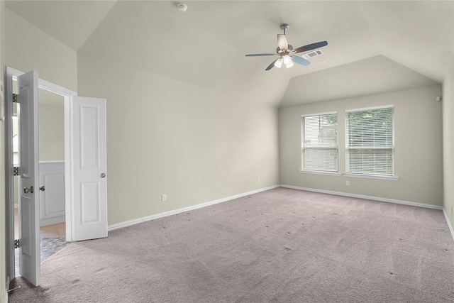 unfurnished room with vaulted ceiling, light colored carpet, and ceiling fan