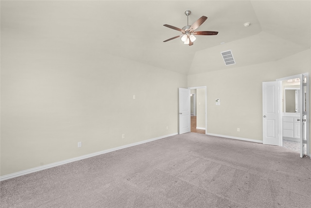 carpeted spare room with lofted ceiling and ceiling fan